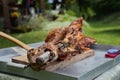 Lamb baked on a spit putted on a table