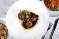 Lamb chops with baked baby potatoes and artichoke sauteed and red wine sauce . Traditional Italian Royalty Free Stock Photo