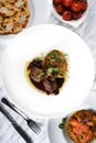 Lamb chops with baked baby potatoes and artichoke sauteed and red wine sauce . Traditional Italian Royalty Free Stock Photo