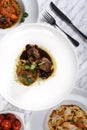 Lamb chops with baked baby potatoes and artichoke sauteed and red wine sauce . Traditional Italian Royalty Free Stock Photo