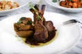 Lamb chops with baked baby potatoes and artichoke sauteed and red wine sauce . Traditional Italian Royalty Free Stock Photo