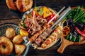 Lamb chops, chicken, veal and mixed meat skewers served on the mixed grilled vegetables