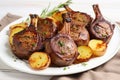 lamb chops with grill marks plated with potatoes