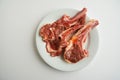 Lamb chops marinated with seasoning and ready for cook on white with copy space. Royalty Free Stock Photo