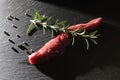 LAMB FILE WITH ROSEMARY ON BLACK BACKGROUND. MEAT AND PEPPER GASTRONOMY PHOTO