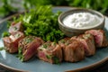 Lamb fillet with mint yoghurt on table. Royalty Free Stock Photo