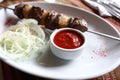 Lamb kebab with fat tail on skewer and sauce