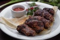 Lamb shish kebab with sauce on a white plate selective focus Royalty Free Stock Photo