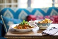 lamb korma on a low table with cushions, traditional eating setting