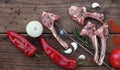 Lamb raw barbecue ribs, paprika and onions,garlic on dark rough boards, horizontal top view Royalty Free Stock Photo