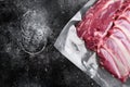 Lamb rib fresh meat Vacuum sealed, on black dark stone table background, top view flat lay, with copy space for text Royalty Free Stock Photo