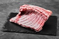 Lamb ribs fresh meat, with eco-friendly packaging. Food Delivery Concept. copy space, dark background Royalty Free Stock Photo