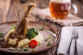 Lamb shank.Confit lamb shank with mashed potatoes spinach and draft beer in pub or restaurant Royalty Free Stock Photo