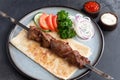 Lamb shashlik on a skewer in a plate Royalty Free Stock Photo