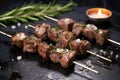 lamb skewers with rosemary twigs and garlic chunks on a stone slab Royalty Free Stock Photo