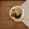 Lamb steak lies on a white plate, on a thin pita bread Royalty Free Stock Photo