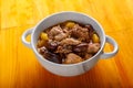 Lamb stewed with potatoes in spices and sauce in a soup bowl on the table