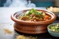 lamb tagine pot enveloped by rising aromatic steam