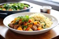 lamb tagine served with side of couscous and vegetables