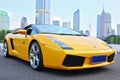 A yellow Lamborghini in guangzhou skyline background