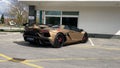 Lamborghini Aventador SVJ brown color in front of a modern building