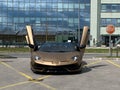 Lamborghini Aventador SVJ brown color in front of a modern building