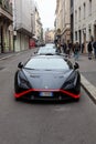 Lamborghini HuracÃ¡n STO super sports car in black parked in Montenapoleone street, Milan