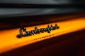 Close Up of Lamborghini Logo on Vibrant Orange Textured Surface Royalty Free Stock Photo