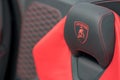 Lamborghini logo stitched on a leather sports car seat red and black