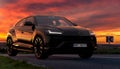 Lamborghini Urus, a luxury sports SUV on the road during a beautiful sunset