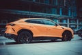 Lamborghini Urus parked on the street in Moscow. Orange supercar in front of office building Royalty Free Stock Photo