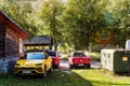 Lamborghini Urus and Volkswagen Amarok cars in a parking lot at a campsite during a motor rally in Altai