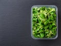 Lambs lettuce in a rectangular food container over black slate background. Fresh corn salad leaves or mache for vitamin vegetable Royalty Free Stock Photo