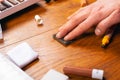 Laminate and parquet restoration repair of wooden furniture sealing scratches and chips. the master polishes the surface close-up