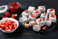 Lamingtons with strawberry jam on a wire rack