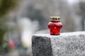 Lamp with candle on granite tombstone outdoors, space for text. Funeral ceremony Royalty Free Stock Photo