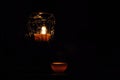 Lamp, candle shining in the darkness. Challis flame. Artistic composition. Royalty Free Stock Photo