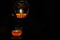 Lamp, candle shining in the darkness. Challis flame. Artistic composition. Royalty Free Stock Photo