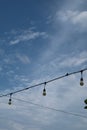 a lamp and electric wires against the background of a bright blue sky. Royalty Free Stock Photo