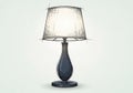 Lamp features a dark, curvaceous base made of what appears to be wood Royalty Free Stock Photo