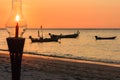 Lamp and fishing boats silhouetted