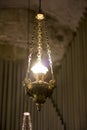 A lamp hanging on an iron chain on a blurred background Royalty Free Stock Photo