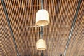 Lamp hanging on slatted ceiling