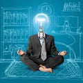 Lamp-head businessman in lotus pose