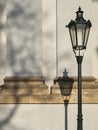 A lamp and its shadow by the wall by the wall of the church