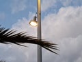 Lamp with light at street at dusk. Sky and clouds. Royalty Free Stock Photo