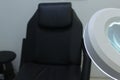 Lamp magnifier for beautician , workplace beautician, black chair Royalty Free Stock Photo