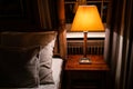 Lamp on a night table next to a bed Royalty Free Stock Photo