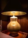 Lamp on a night table next to a bed Royalty Free Stock Photo