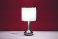 Lamp on a night table next to a bed. Royalty Free Stock Photo